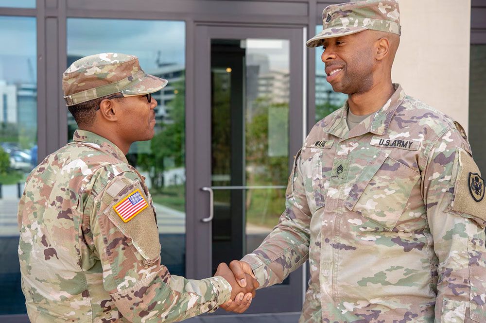 Two service members shaking hands